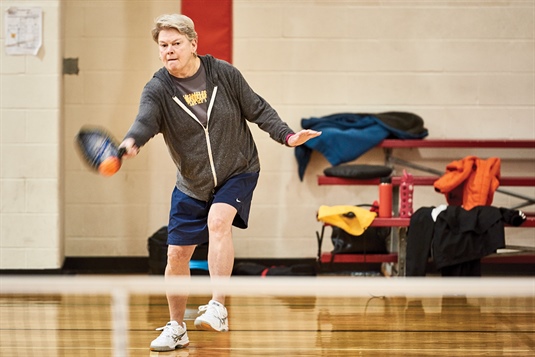 Deborah Quesenberry volleys during paddleball.