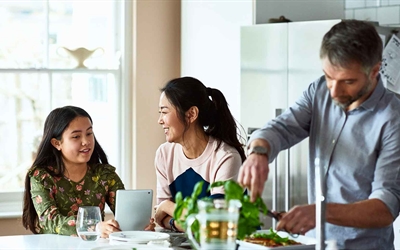 Stock photo of young family in kitchen preparing healthy meal