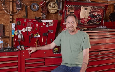 Rich Welmon stroke survivor sits in his workshop.