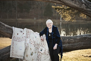 Betty Mesplay with a quilt of hers